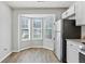 Bright kitchen eating area with a large bay window and stainless steel refrigerator at 3188 Kingswood Gln, Decatur, GA 30034