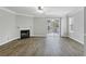 Cozy living room with wood floors, fireplace, and sliding glass door to the outdoor deck at 3188 Kingswood Gln, Decatur, GA 30034