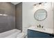 Modern bathroom with a gray tiled shower, vanity, and patterned tile floor at 478 Majestic Oaks Pl, Smyrna, GA 30082