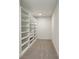 Walk-in closet with built-in shelving and carpeted floor at 478 Majestic Oaks Pl, Smyrna, GA 30082