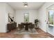 A modern dining room with wood floors is enhanced by panelled walls, sleek furniture, and natural light, creating a welcoming space at 478 Majestic Oaks Pl, Smyrna, GA 30082