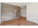 Hallway with hardwood floors and wood slat wall that provides unique visual separation and architectural interest at 478 Majestic Oaks Pl, Smyrna, GA 30082