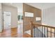 Hallway featuring a decorative wood slat wall with planters and a view into the bright living room at 478 Majestic Oaks Pl, Smyrna, GA 30082