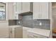 Stylish kitchen with gray cabinets, gold hardware, white quartz countertops, and a sleek gray backsplash at 478 Majestic Oaks Pl, Smyrna, GA 30082