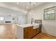 Bright open kitchen featuring an island with a farmhouse sink, quartz countertops, and stainless steel appliances at 478 Majestic Oaks Pl, Smyrna, GA 30082