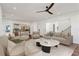 Living room with a ceiling fan open to the kitchen, featuring hardwood floors and neutral decor at 478 Majestic Oaks Pl, Smyrna, GA 30082