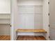 Mudroom with a built-in bench, paneled walls, and open shelving for convenient storage at 478 Majestic Oaks Pl, Smyrna, GA 30082