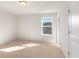 Bright bedroom with a large window offering natural light and neutral carpet flooring at 4793 Moonstone Trce, Kennesaw, GA 30144