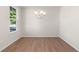 Bright dining room featuring wood floors, a modern chandelier, a large window and neutral paint at 4793 Moonstone Trce, Kennesaw, GA 30144