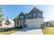 Two-story home featuring a two-car garage, stone accents, and a covered front porch, surrounded by a well-manicured lawn at 4793 Moonstone Trce, Kennesaw, GA 30144