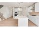 Open-concept kitchen with white cabinets, a central island with quartz countertops, and modern stainless steel appliances at 4793 Moonstone Trce, Kennesaw, GA 30144