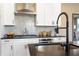 Close-up of a modern kitchen with stainless steel appliances, granite countertops, and updated fixtures at 4793 Moonstone Trce, Kennesaw, GA 30144