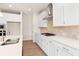 Modern kitchen featuring white cabinets, stainless steel appliances, quartz countertops, and wood floors at 4793 Moonstone Trce, Kennesaw, GA 30144