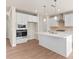 Bright kitchen featuring white cabinetry, stainless steel appliances, quartz countertops, and a large central island at 4793 Moonstone Trce, Kennesaw, GA 30144