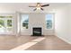 Bright living room featuring a fireplace, wood flooring, and access to outdoor deck at 4793 Moonstone Trce, Kennesaw, GA 30144