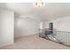 Bright loft area with neutral carpeting and classic black metal stair railing at 4793 Moonstone Trce, Kennesaw, GA 30144