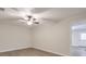 This bedroom features hardwood floors, a ceiling fan and a large window at 305 Hembree Grove Trce, Roswell, GA 30076