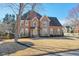 Beautiful two-story home with brick facade, manicured landscaping, and a welcoming entrance at 305 Hembree Grove Trce, Roswell, GA 30076