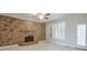 Cozy living room featuring a stone fireplace and plantation shutters at 305 Hembree Grove Trce, Roswell, GA 30076