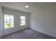 Carpeted bedroom featuring two windows that allow ample natural light at 3187 Moor View Rd # 37, Duluth, GA 30096