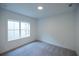 Carpeted bedroom featuring a window that allows ample natural light at 3187 Moor View Rd # 37, Duluth, GA 30096