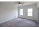 Cozy bedroom featuring neutral carpeting, white walls, recessed lights and two windows at 3187 Moor View Rd # 37, Duluth, GA 30096