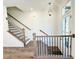 The staircase features wood handrails, black metal balusters, and bright lighting at 3187 Moor View Rd # 37, Duluth, GA 30096