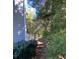 Landscaped backyard includes a path between the home and greenery at 3980 Bayside Cir, Atlanta, GA 30340