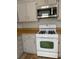 Close-up view of the kitchen range and microwave, highlighting the functional layout and design at 3980 Bayside Cir, Atlanta, GA 30340