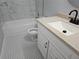 Bathroom features a vanity with white cabinetry, white tub, and black & white tiled floor at 434 Ridgetop Nw Dr, Acworth, GA 30102