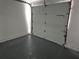 Clean and empty garage with a bright, white door on a cement floor at 434 Ridgetop Nw Dr, Acworth, GA 30102