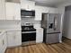 Modern kitchen featuring stainless steel appliances and white cabinetry at 434 Ridgetop Nw Dr, Acworth, GA 30102