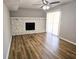 Bright living room features a fireplace, ceiling fan, and wood floors at 434 Ridgetop Nw Dr, Acworth, GA 30102