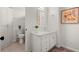 Bathroom featuring a toilet, linen closet, and vanity with ample storage, and modern mirror at 500 River Bluff Pkwy, Roswell, GA 30075