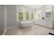 Serene bathroom featuring a freestanding tub, double vanities, and natural light at 500 River Bluff Pkwy, Roswell, GA 30075