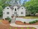 Beautiful home featuring a manicured front yard and detailed architectural elements with a winding walkway at 500 River Bluff Pkwy, Roswell, GA 30075