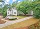 Beautiful house with pristine landscaping and a long driveway leading up to the elegant residence at 500 River Bluff Pkwy, Roswell, GA 30075