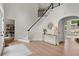 Open concept foyer with staircase, hardwood floors, and a view to a naturally lit room at 500 River Bluff Pkwy, Roswell, GA 30075