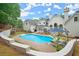 Backyard pool area features ample seating, lush plants, an expansive patio, and manicured lawn at 500 River Bluff Pkwy, Roswell, GA 30075