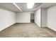 Open basement area with neutral carpet and easy access to other rooms at 1280 Pinyon Pl, Lawrenceville, GA 30043
