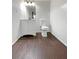 Bathroom with white vanity, toilet, and wainscoting at 1280 Pinyon Pl, Lawrenceville, GA 30043