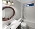 Bathroom featuring a stylish vanity, a large framed mirror, and a shower-tub combo at 1280 Pinyon Pl, Lawrenceville, GA 30043