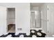 Bathroom with sleek tile flooring, stand-up shower and walk-in closet access at 1280 Pinyon Pl, Lawrenceville, GA 30043