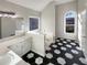 Bathroom with double sinks, stylish black and white flooring and a jacuzzi tub at 1280 Pinyon Pl, Lawrenceville, GA 30043