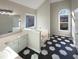 Bright bathroom featuring hexagon tile flooring, garden tub, and large windows at 1280 Pinyon Pl, Lawrenceville, GA 30043