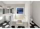 Bathroom featuring double sinks, stylish black and white flooring, tub and toilet at 1280 Pinyon Pl, Lawrenceville, GA 30043