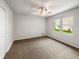 Comfortable bedroom with ceiling fan, closet and a view of the outdoors at 1280 Pinyon Pl, Lawrenceville, GA 30043
