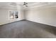 Bedroom featuring a tray ceiling, carpet floors and a large window at 1280 Pinyon Pl, Lawrenceville, GA 30043