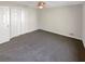 Bright bedroom with plush carpet flooring, closet with folding doors, and ceiling fan at 1280 Pinyon Pl, Lawrenceville, GA 30043