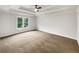 Bedroom featuring tray ceiling and a large window at 1280 Pinyon Pl, Lawrenceville, GA 30043